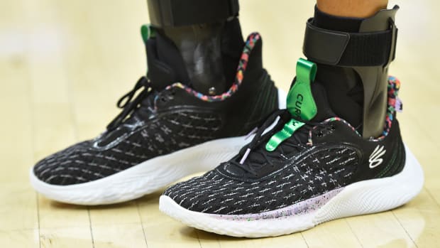 Golden State Warriors point guard Stephen Curry wearing the Sesame Street x Curry Flow 9 'Street Pack - Count It'